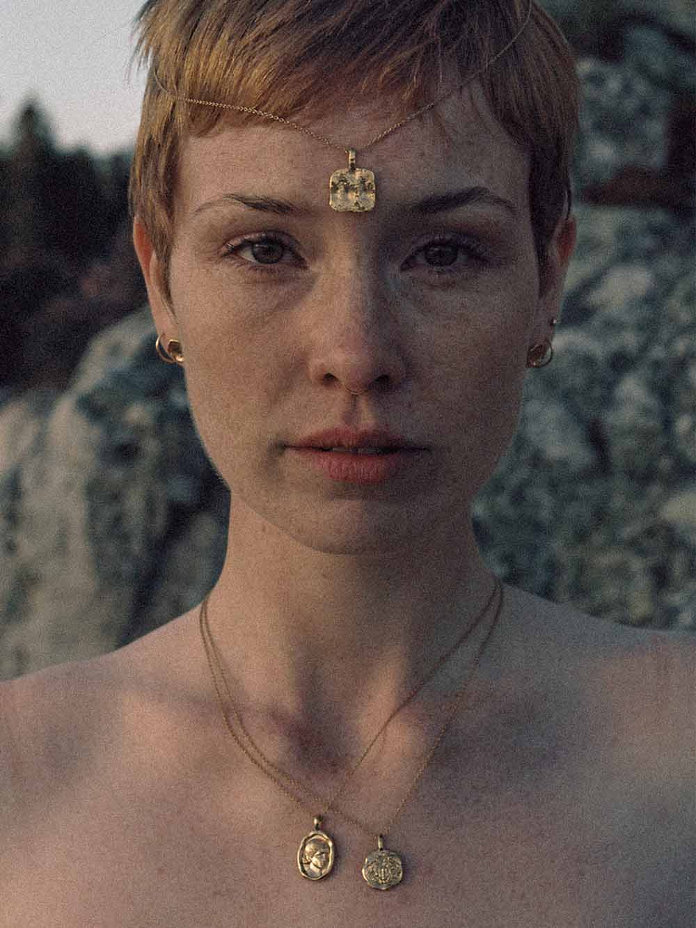 Woman wearing Common Era gold jewelry with a headpiece, goddess collection editorial